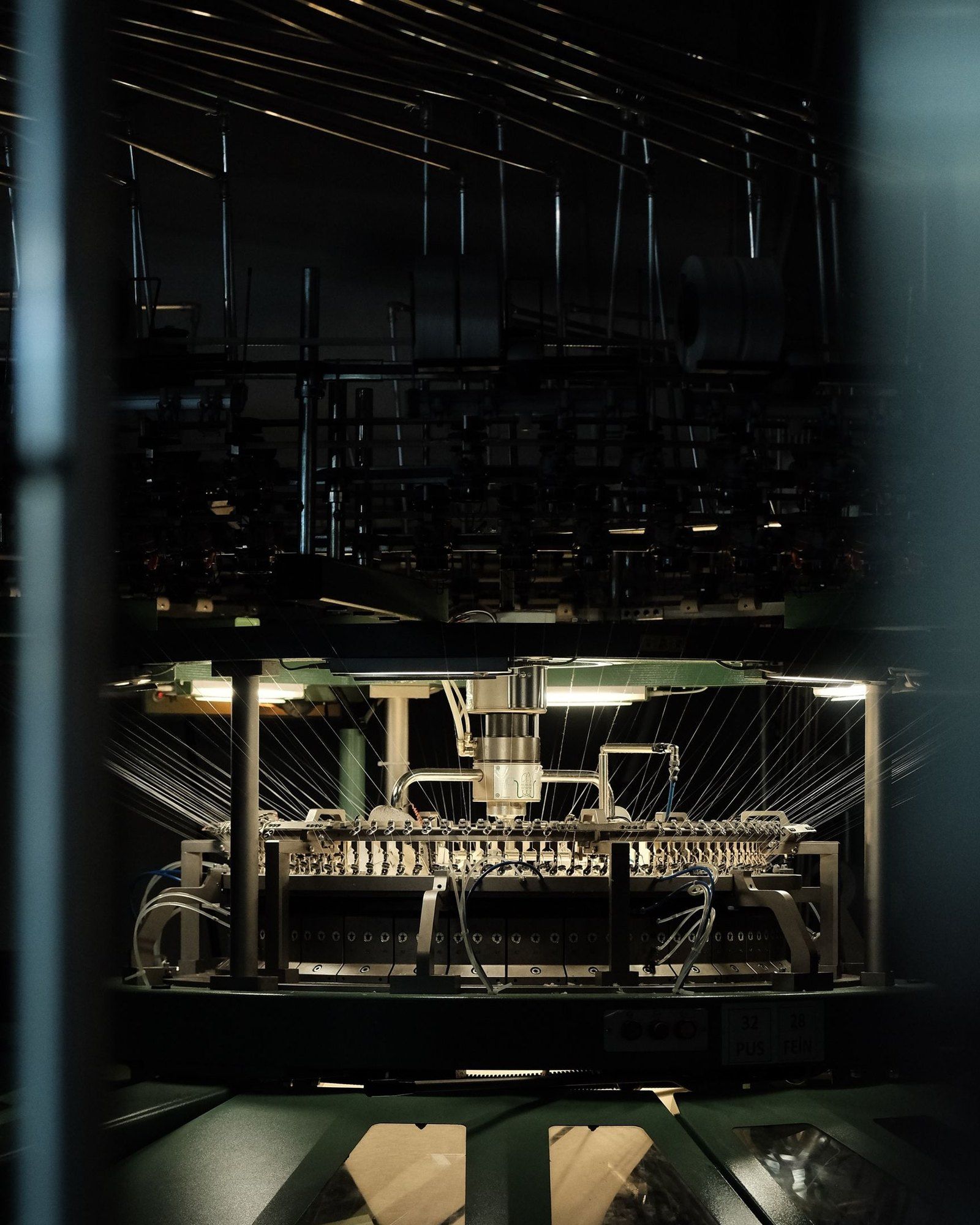A knitting machine running under low light